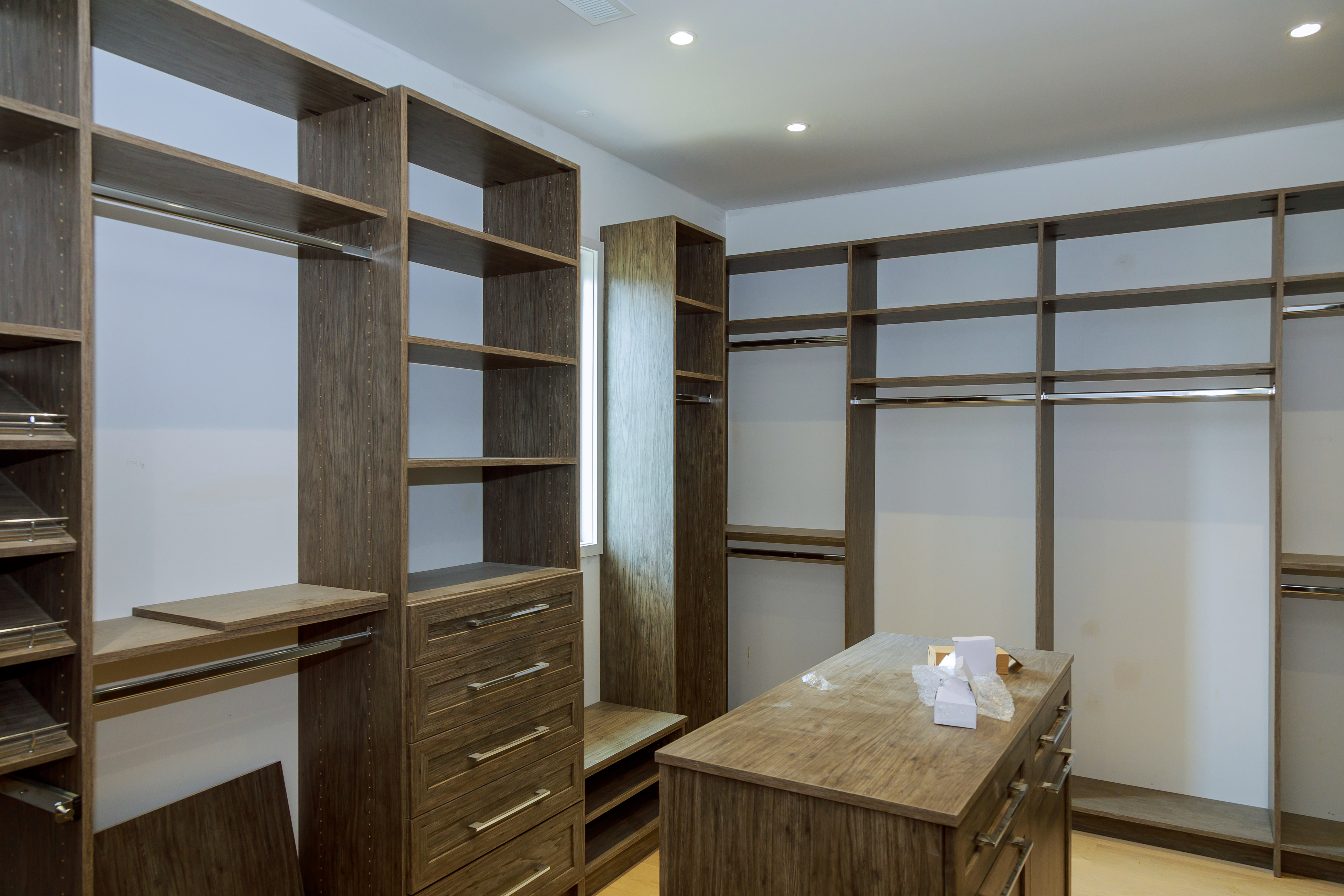 A new closet remodel in dark wood with extra shelving and drawers