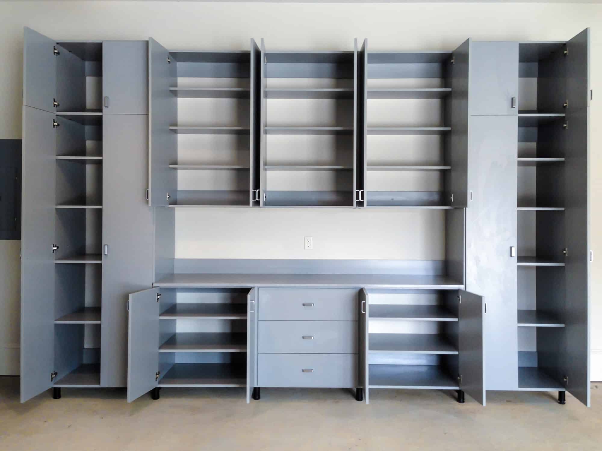 Grey garage storage system with cabinets and shelving