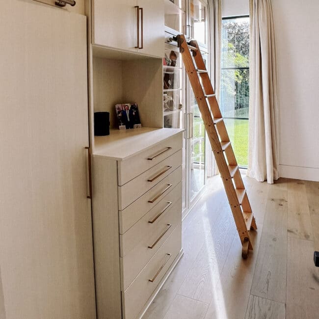 white shelves in closet with ladder