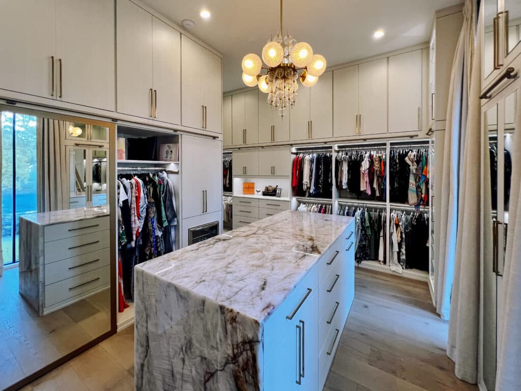 beautiful custom built closet with marble island