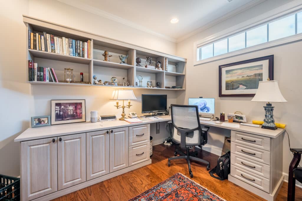 custom built desk area in home with white cabinetry