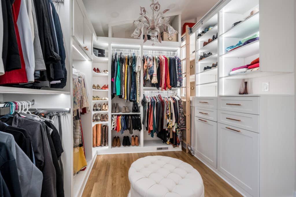 sitting area and clothes storage in a custom closet built by ruffino custom closets